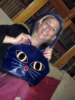 Eleni Calligas holds a purse with a cat face, showing her love of felines