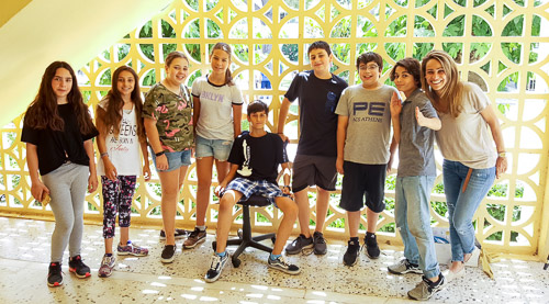 The student stray animal rescue group pose with their teacher