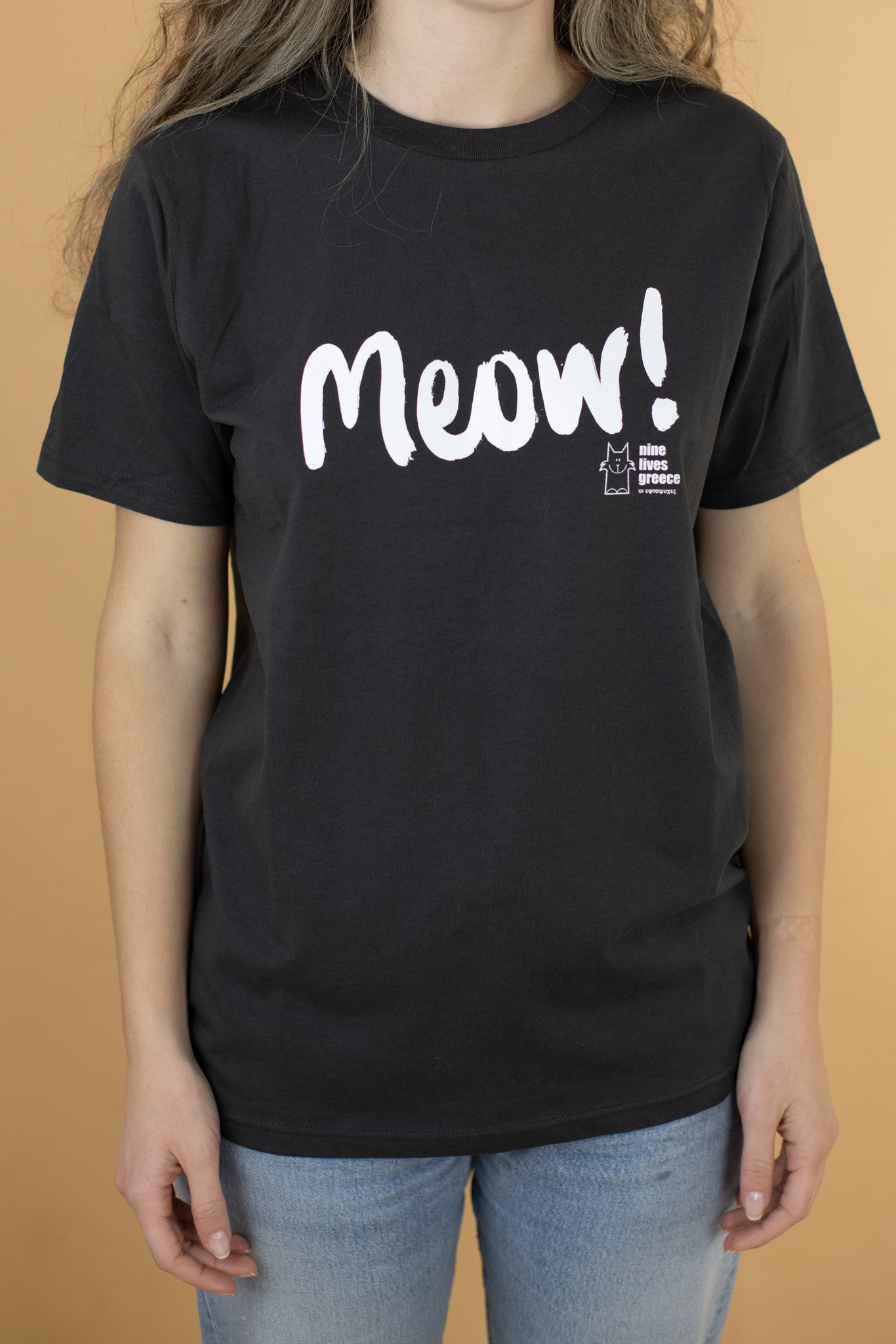 Black t-shirt with the word Meow printed on it.