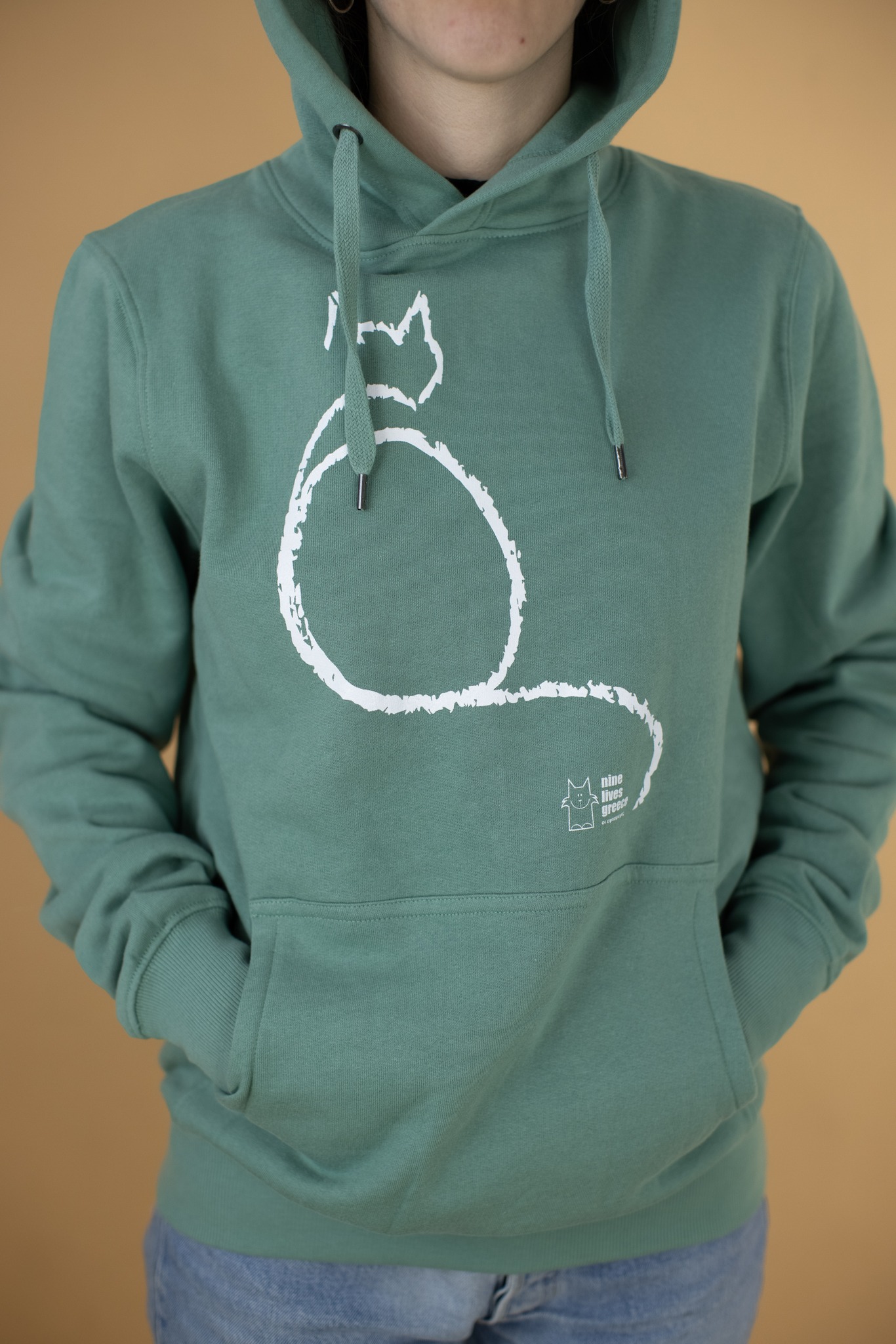 A sage green hoodie with a white sitting cat design.